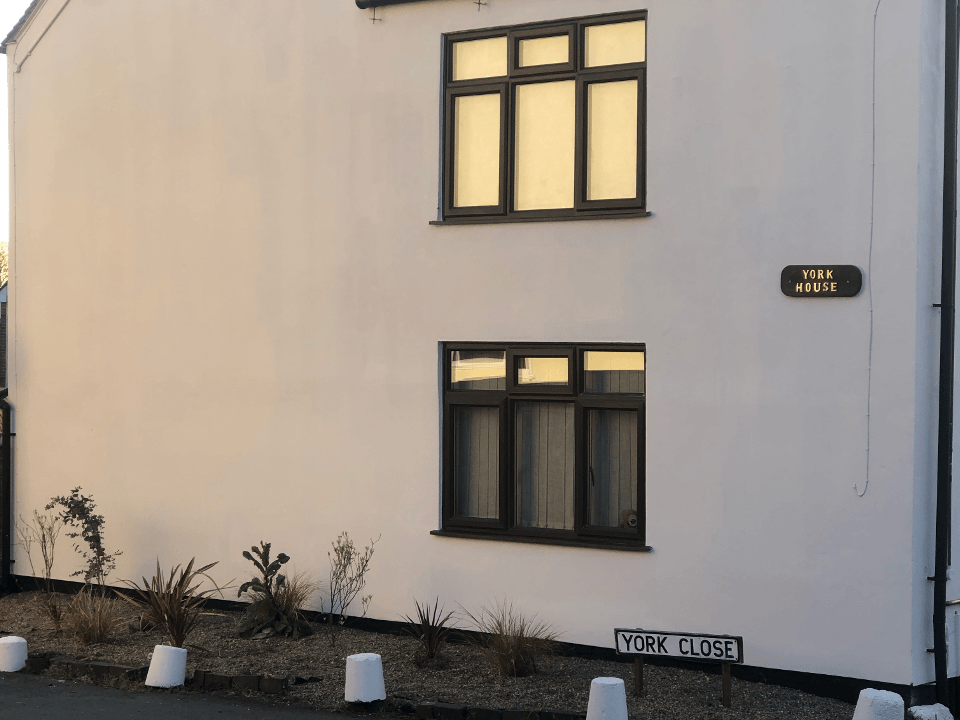 Picture of the side of a house painted in white render by Painters and Decorators Birmingham