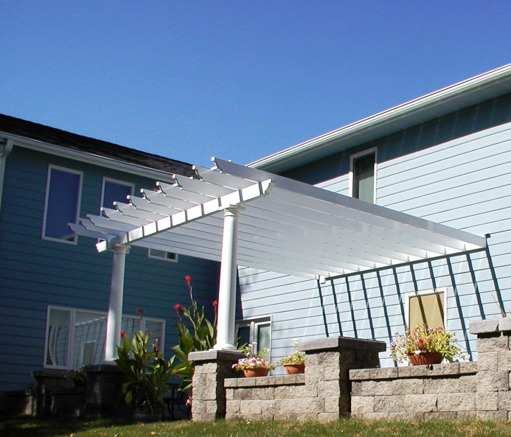 A blue house with a white pergola 