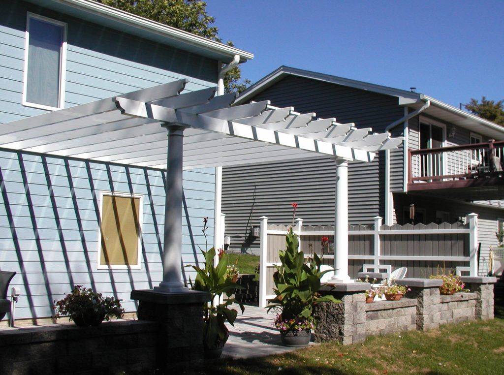 A blue house with a white pergola 