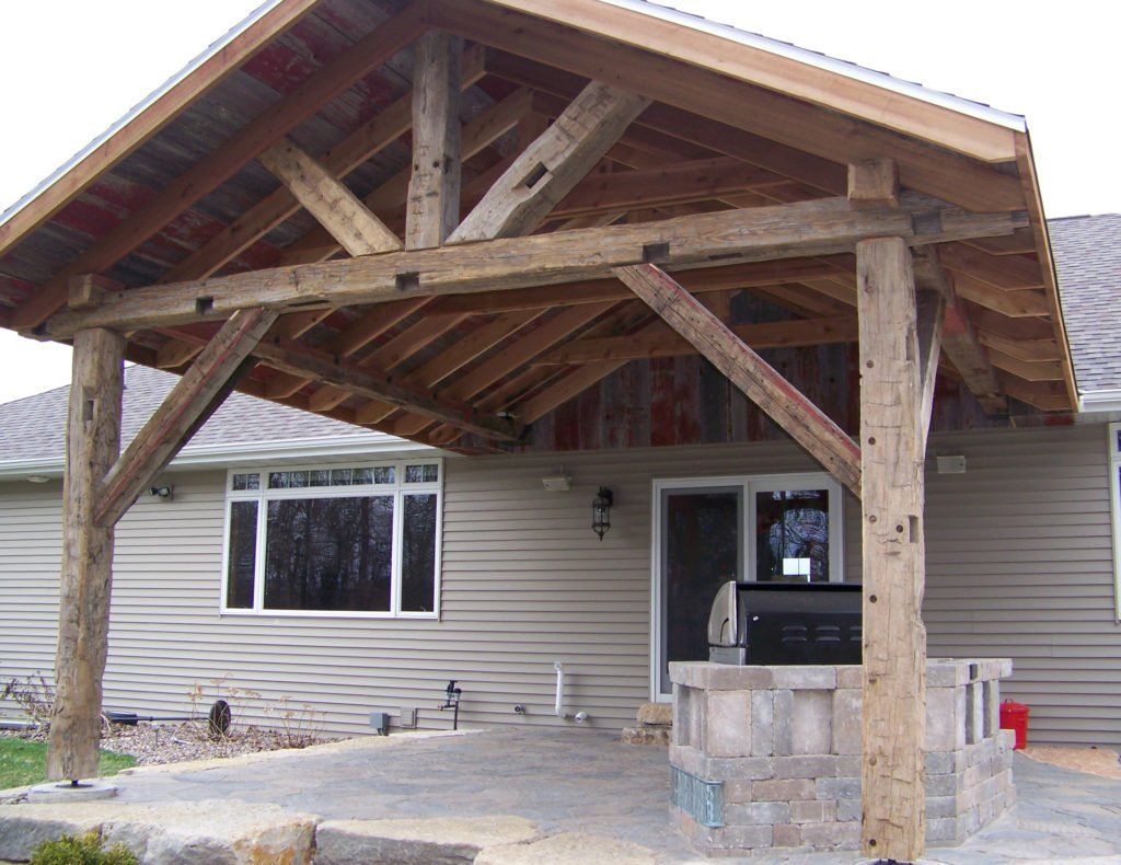 A house with a large wooden structure in front of it