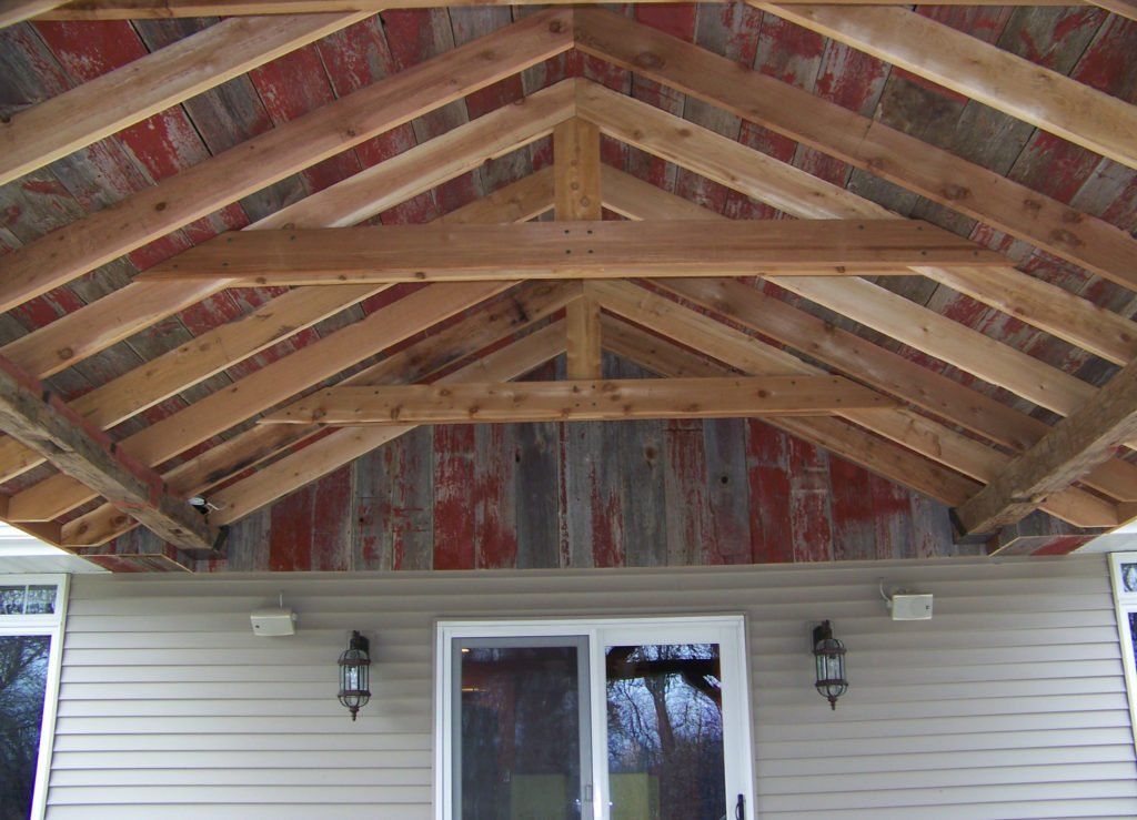 The roof of a house is being built with wooden beams.