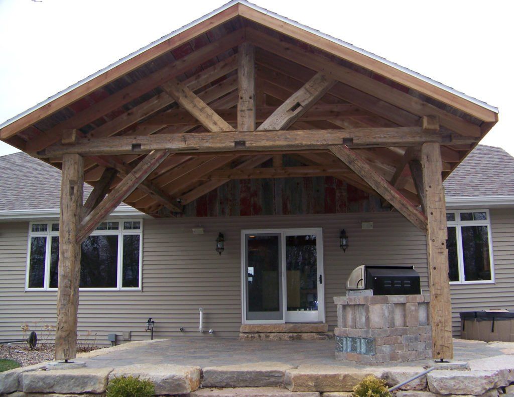 The back of a house with a large wooden roof