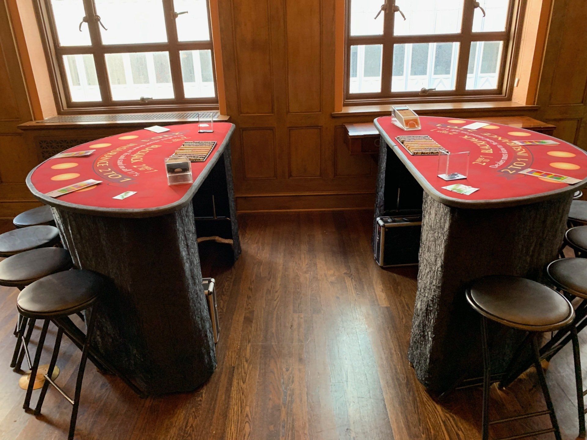 Two tables with cards on them are sitting next to each other in a room.