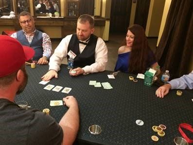 A group of people are sitting around a table playing poker.