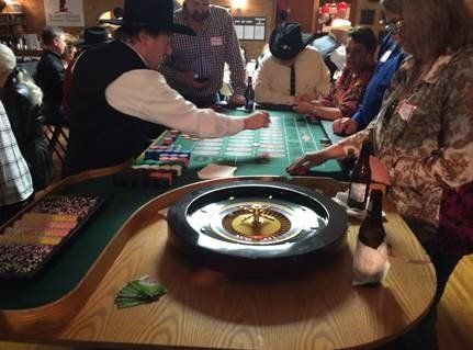 A group of people are playing roulette in a casino.