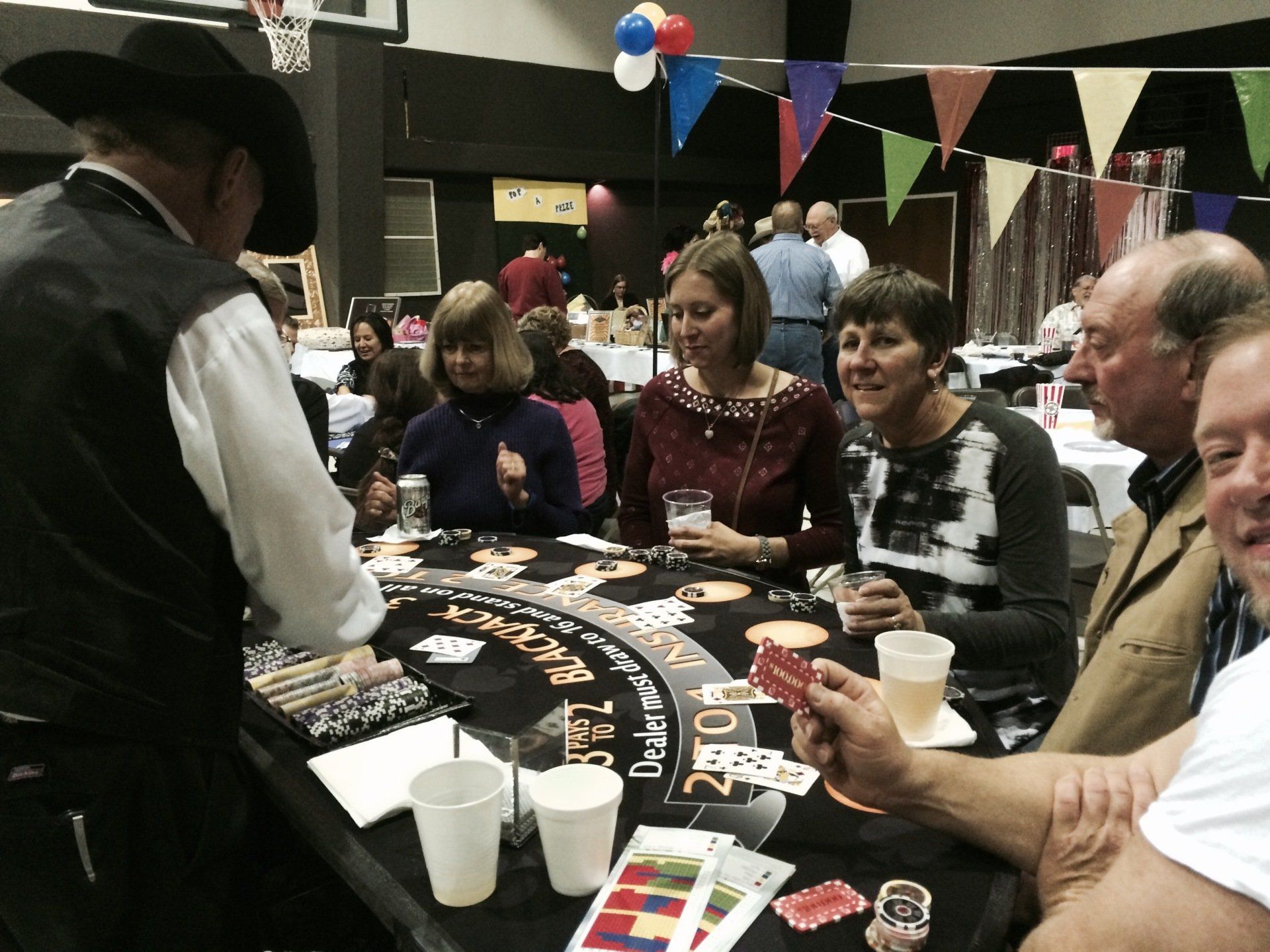 A group of people are playing a game of baccarat