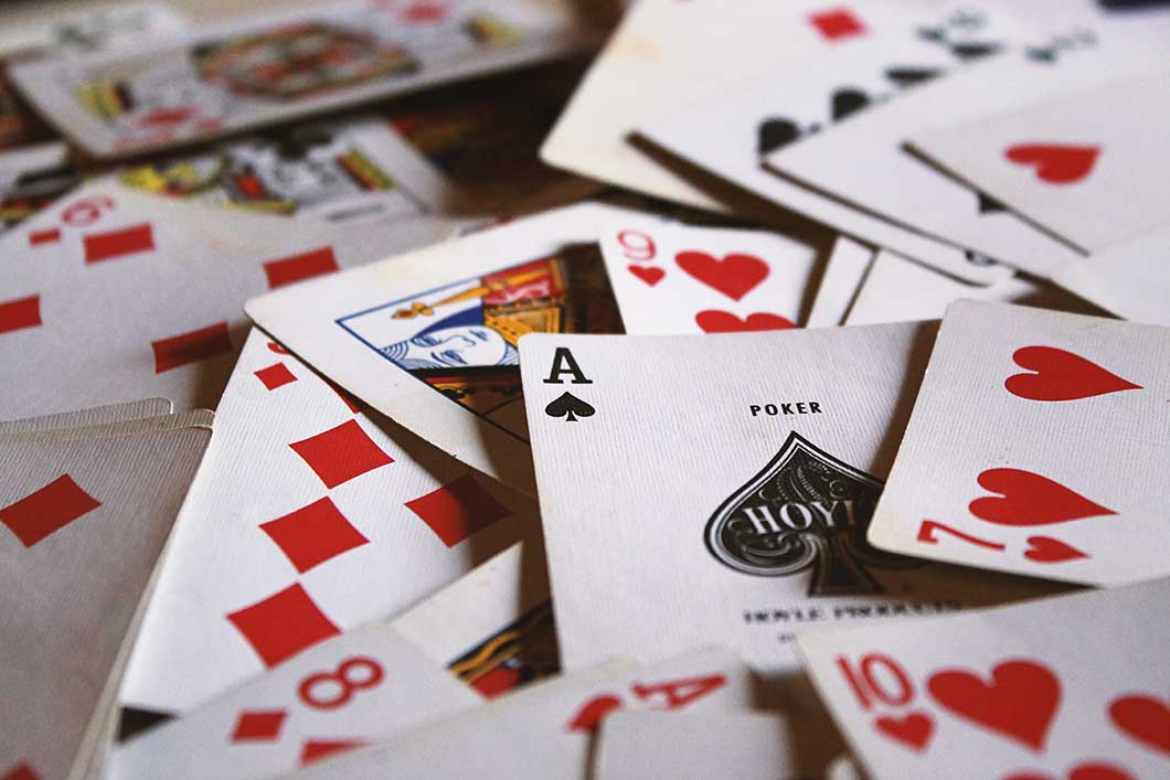 A pile of playing cards with the ace of spades on top