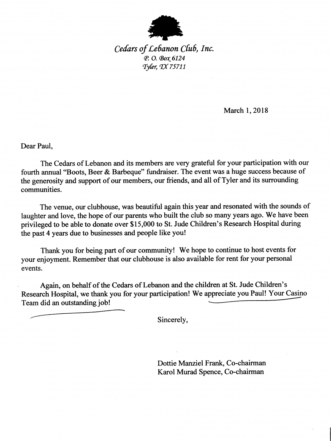 A letter with a tree on it is on a piece of paper.