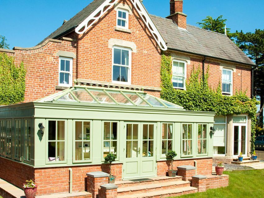 Green Colouored Home Conservatory and Front Door. Installed by Holts Orangeries.