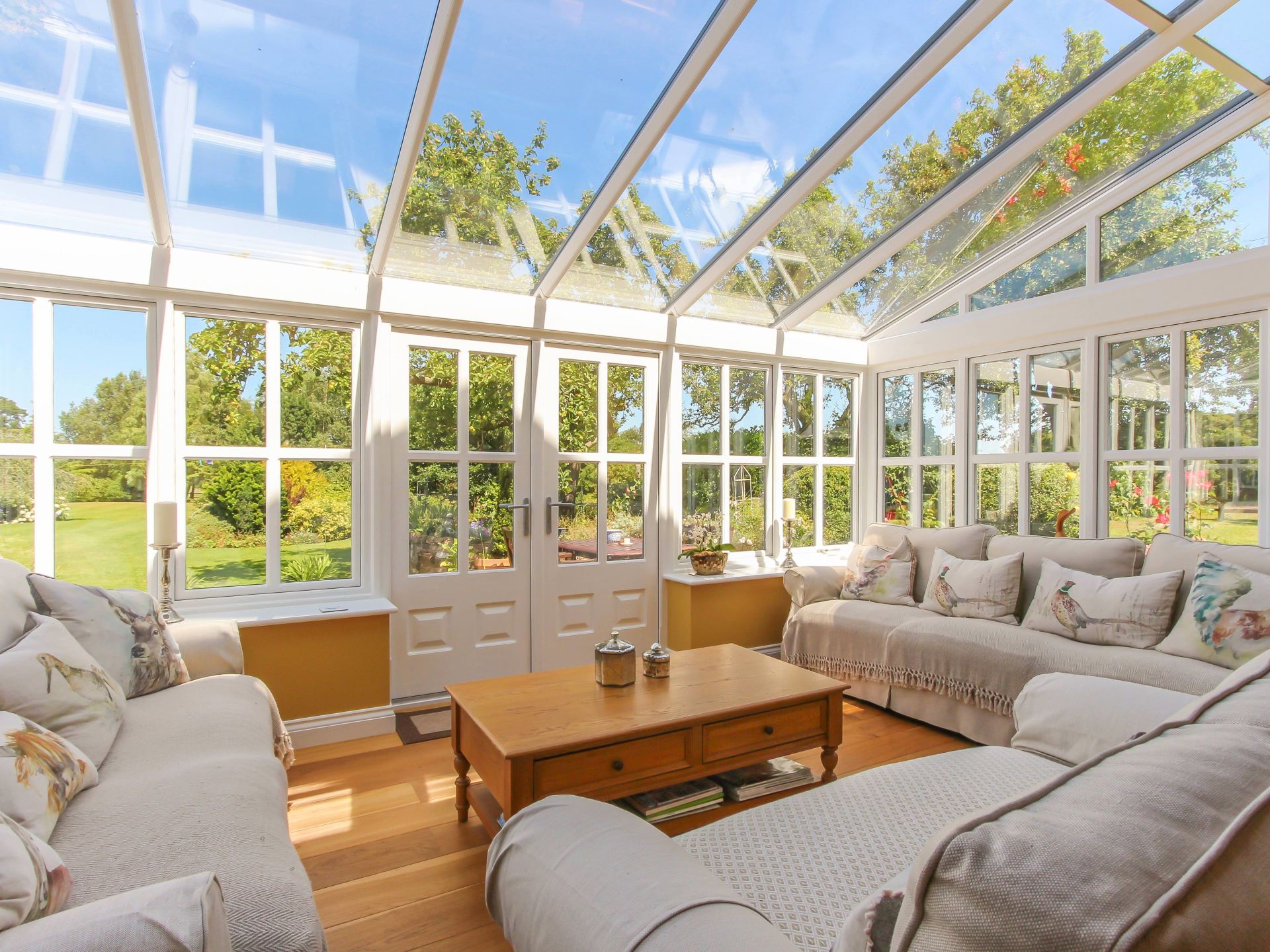 Interior View of Home Orangery as Living Space with 3 Couches and a Wooden Coffee Table
