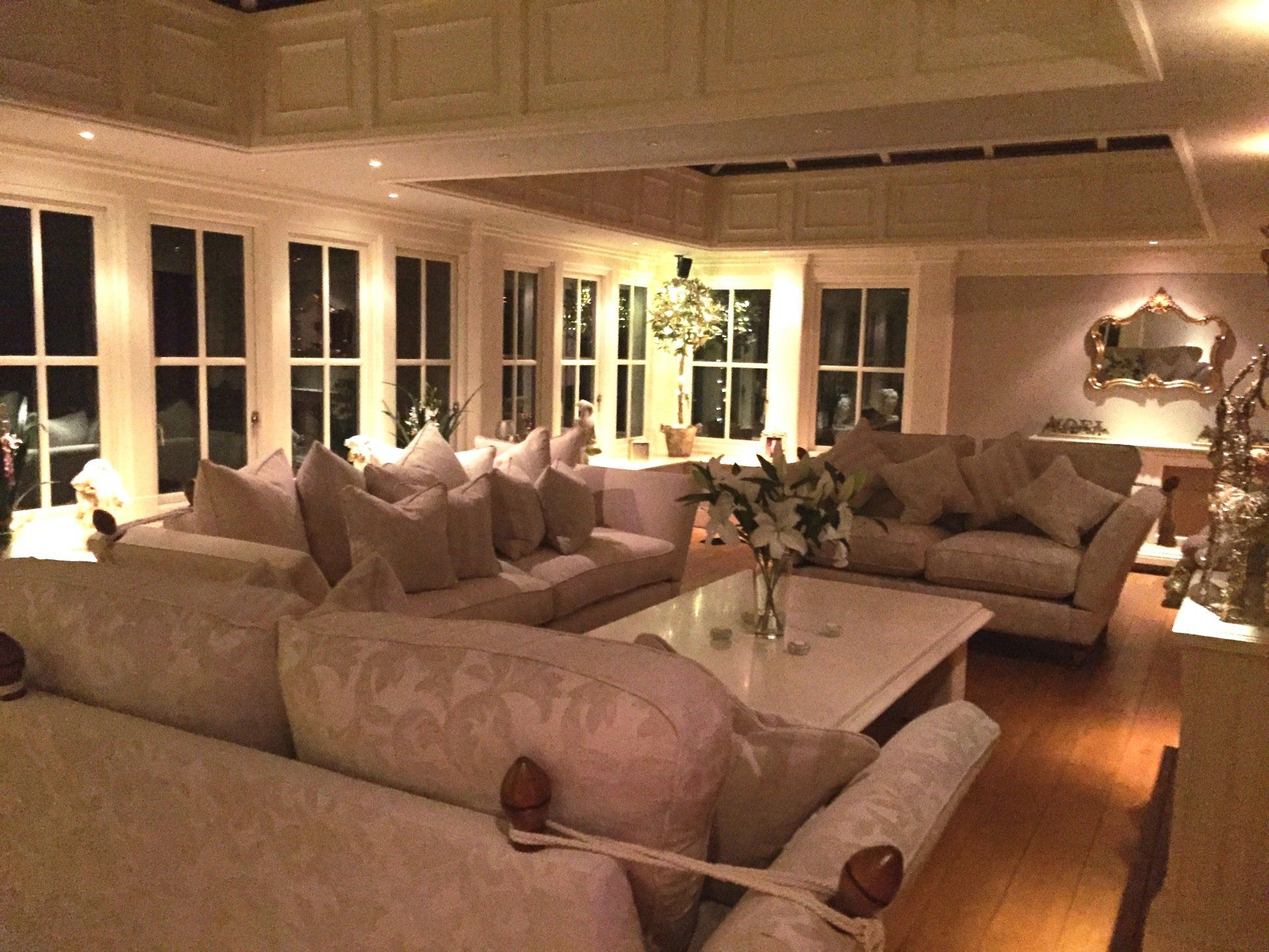 Interior View of Home Orangery as Living Space with 3 Couches and Marble Coffee Table
