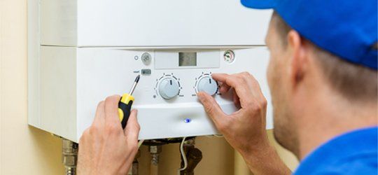 Emergency Plumbing — Worker Setting Up the Gas Heating Boiler in Columbia, TN