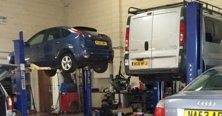Blue car and van in garage