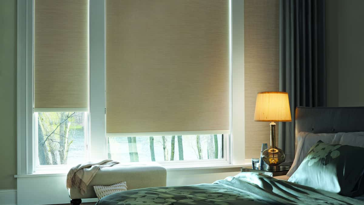 Custom roller shades in a bedroom