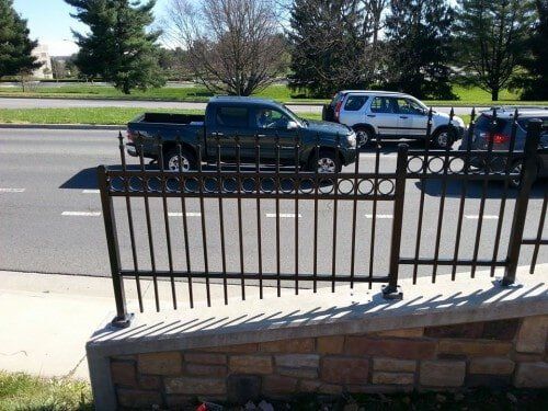 Wrought iron fence by road