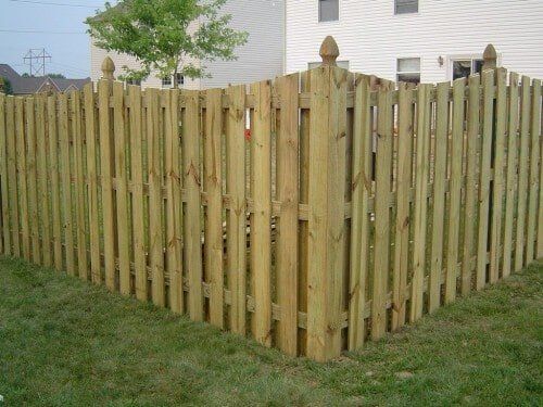 Scalloped wood picket fence.