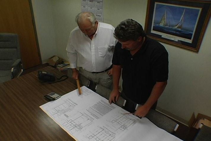 Engineers working at analyzing the project drawing