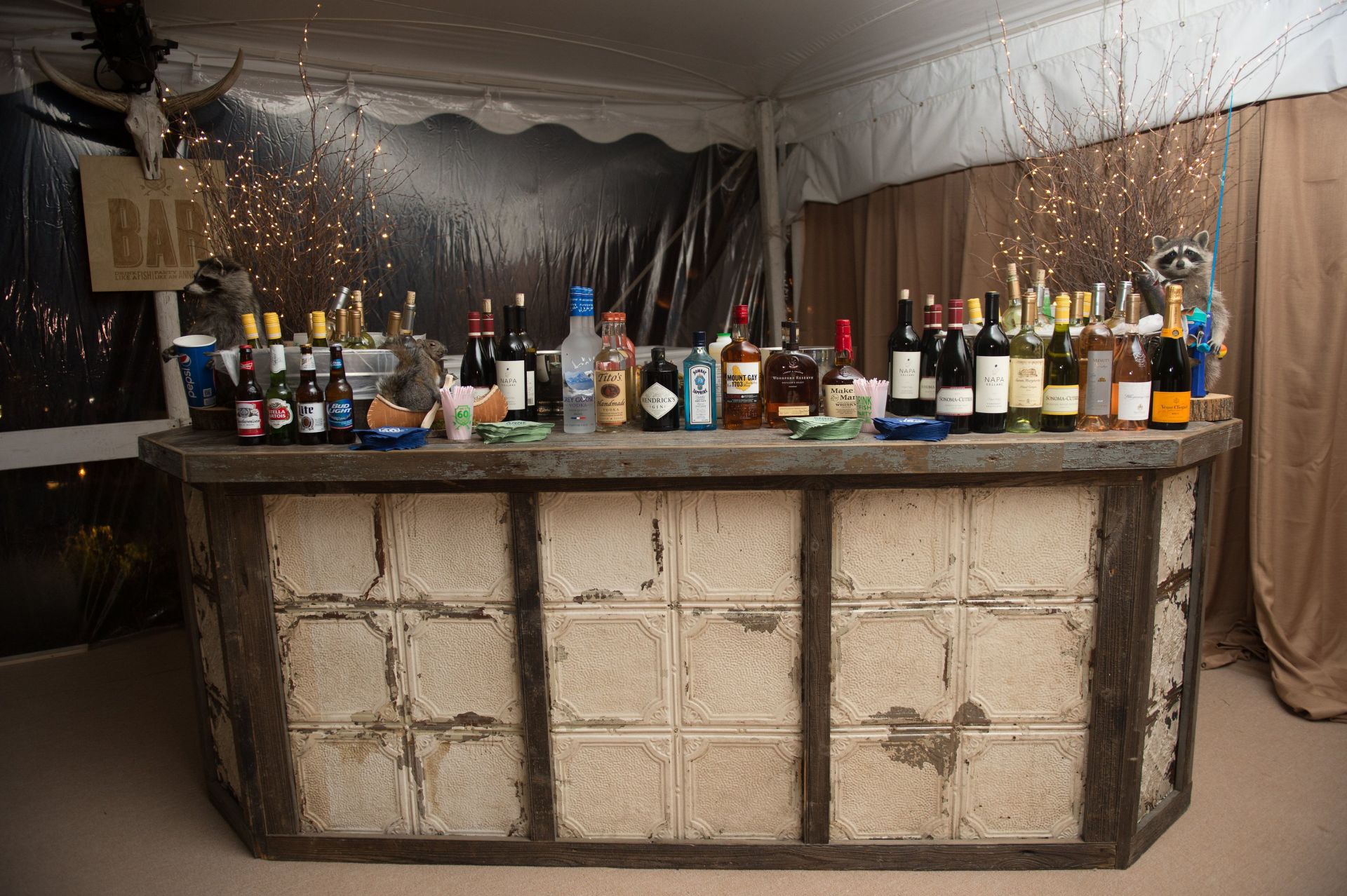 A bar with a lot of bottles of alcohol on it.