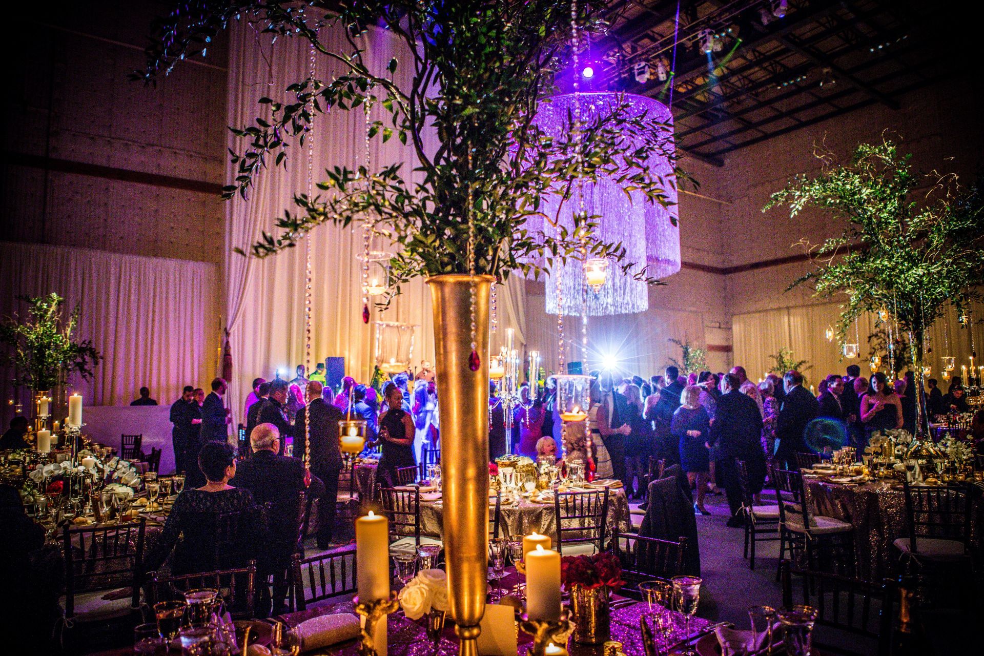 A large room filled with tables and chairs and a tree in the middle.