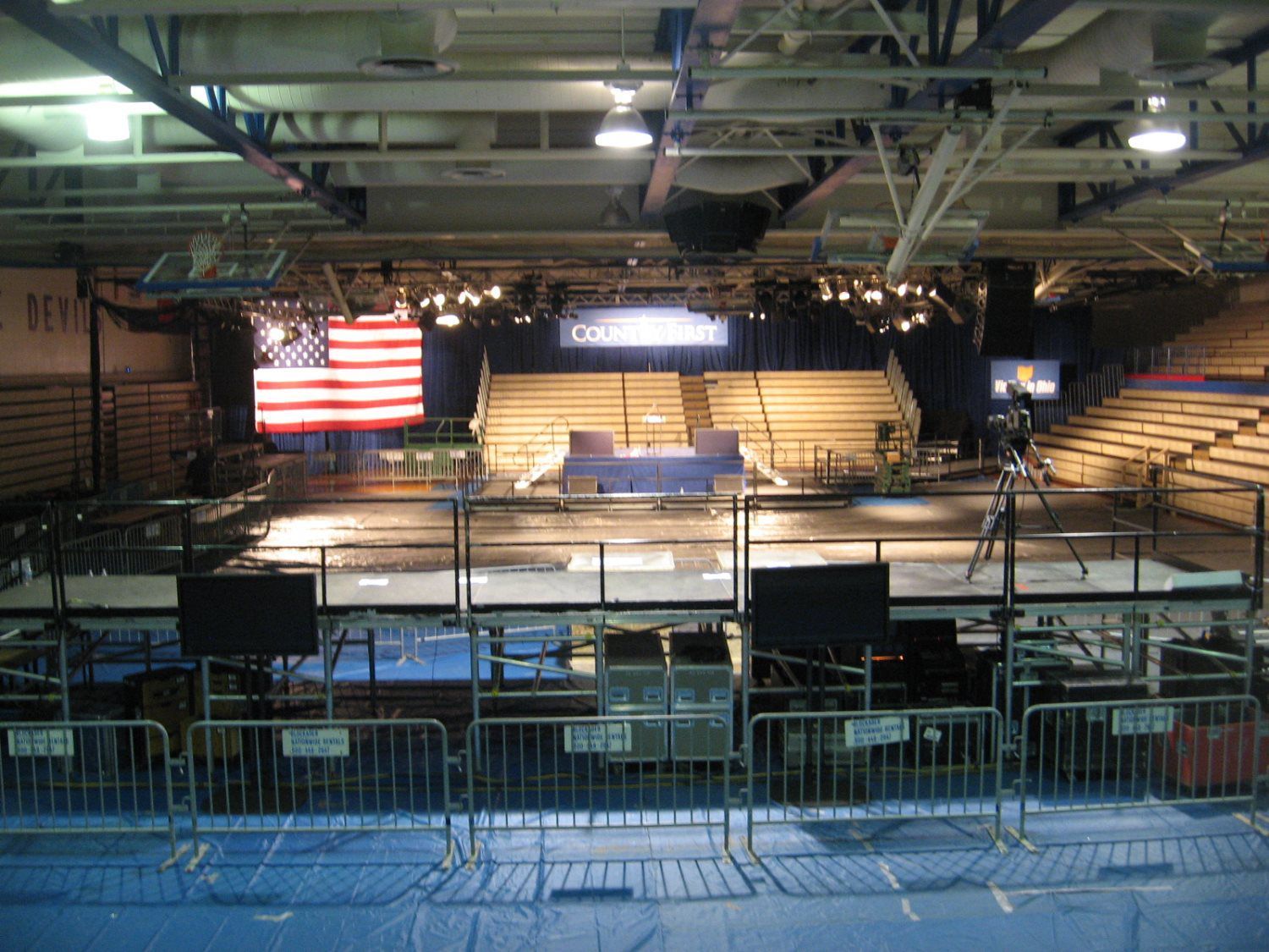 An american flag is hanging from the ceiling of a stadium