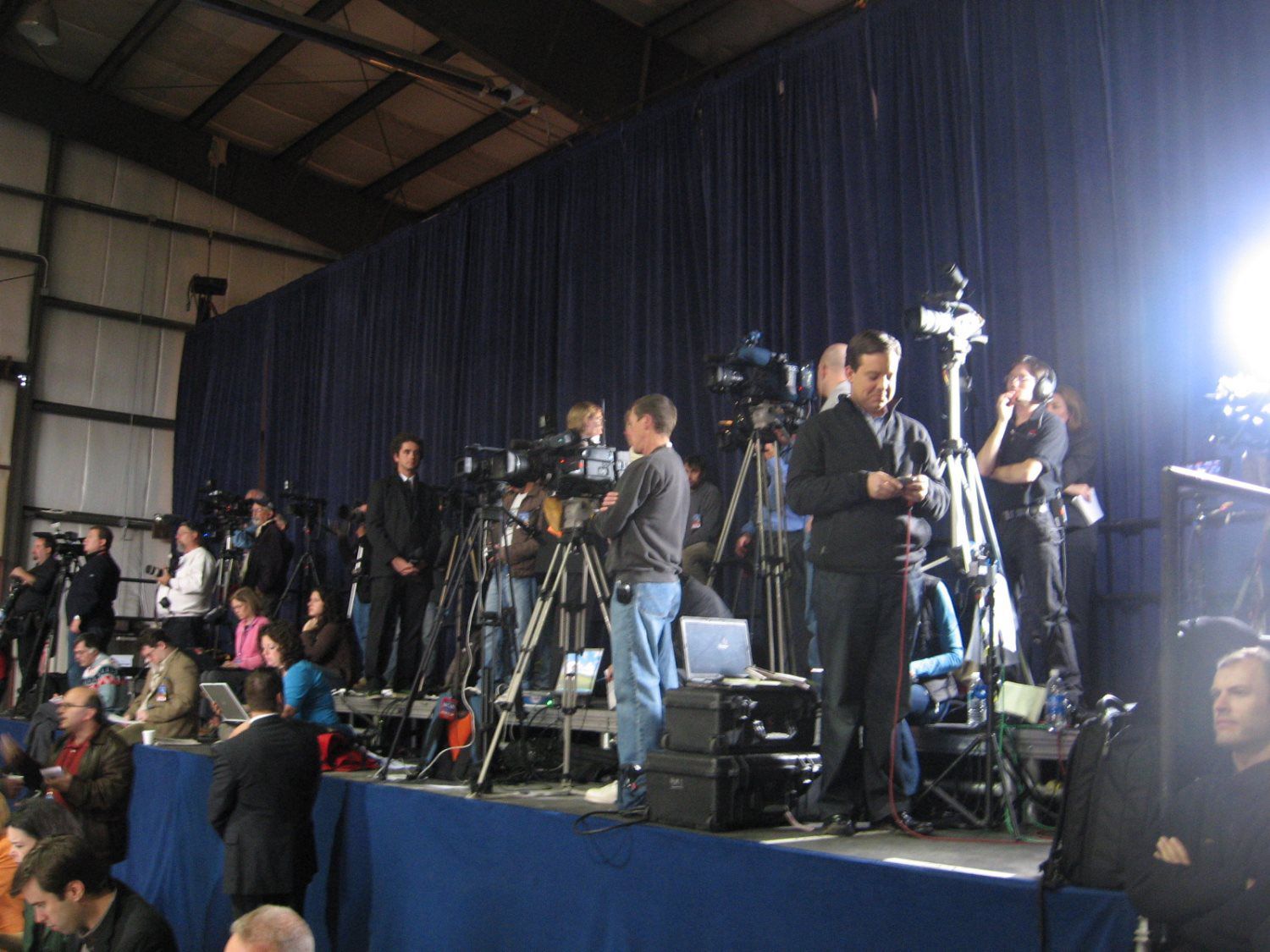 A group of people standing on a stage with cameras