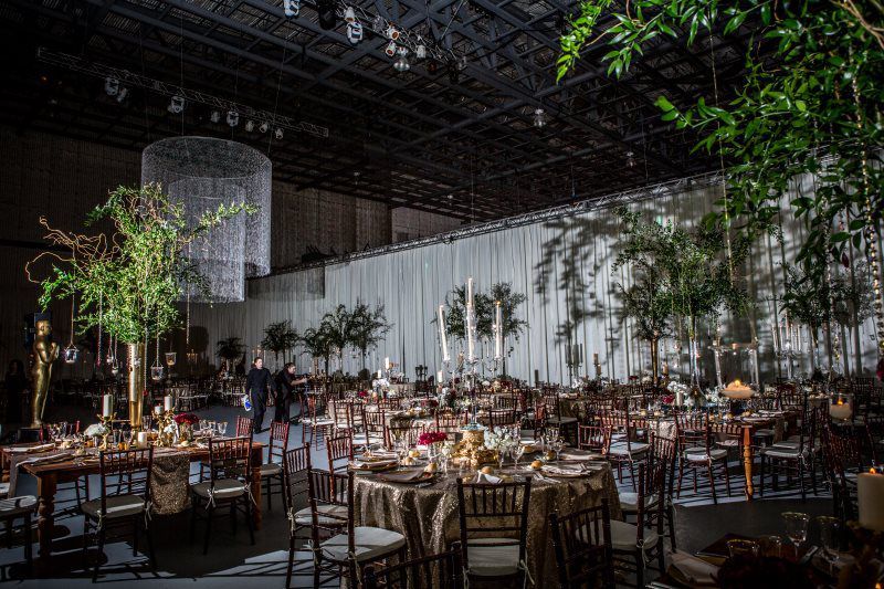 A large room with tables and chairs set up for a wedding reception.