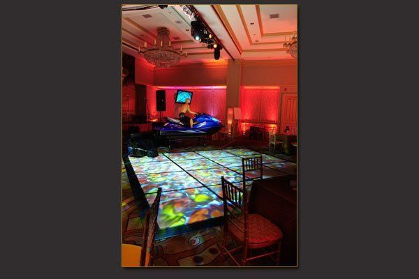 A large room with a dance floor and chairs