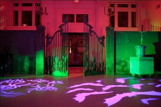 A gate is lit up with green and purple lights