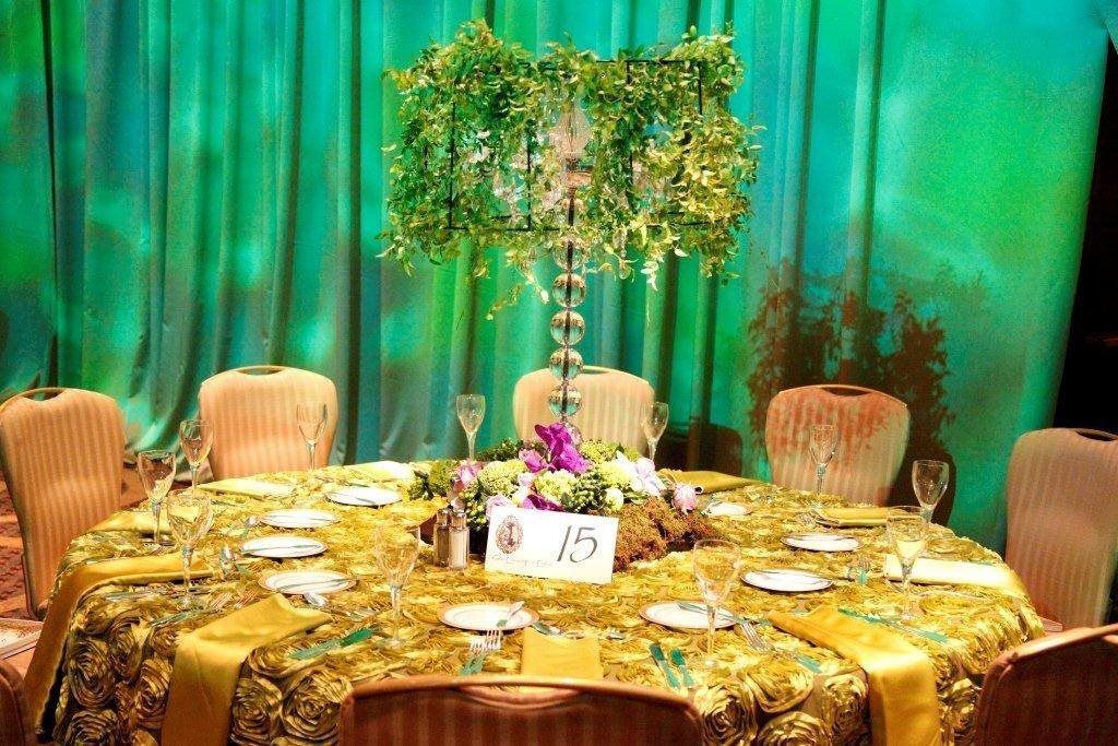 A table with a vase of flowers on it and a table number on it.