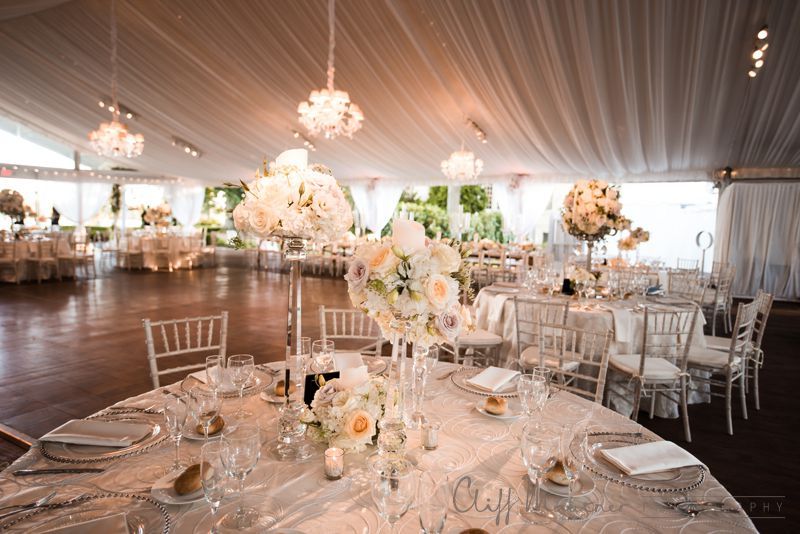A large room with tables and chairs set up for a wedding reception.