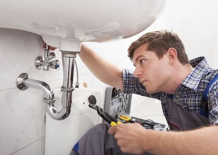 Plumber fixing a sink - Sewer Cleaning in Amesbury, MA Plumber fixing a sink - Sewer Cleaning in Amesbury, MA