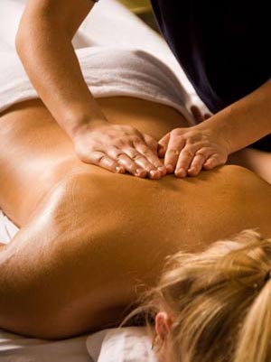A woman is getting a massage on her back.