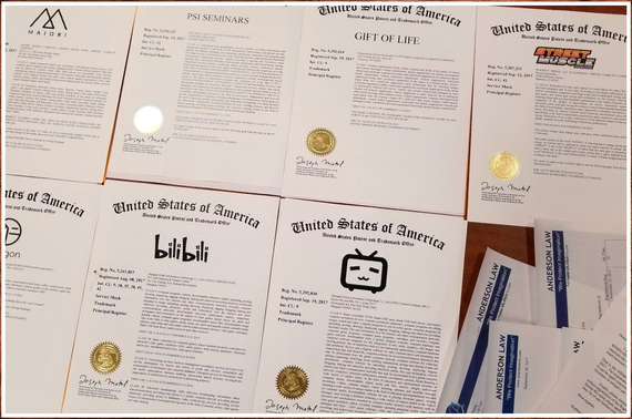 ANDERSON LAW Trademark Registration certificates with logos, seals, and text, including 