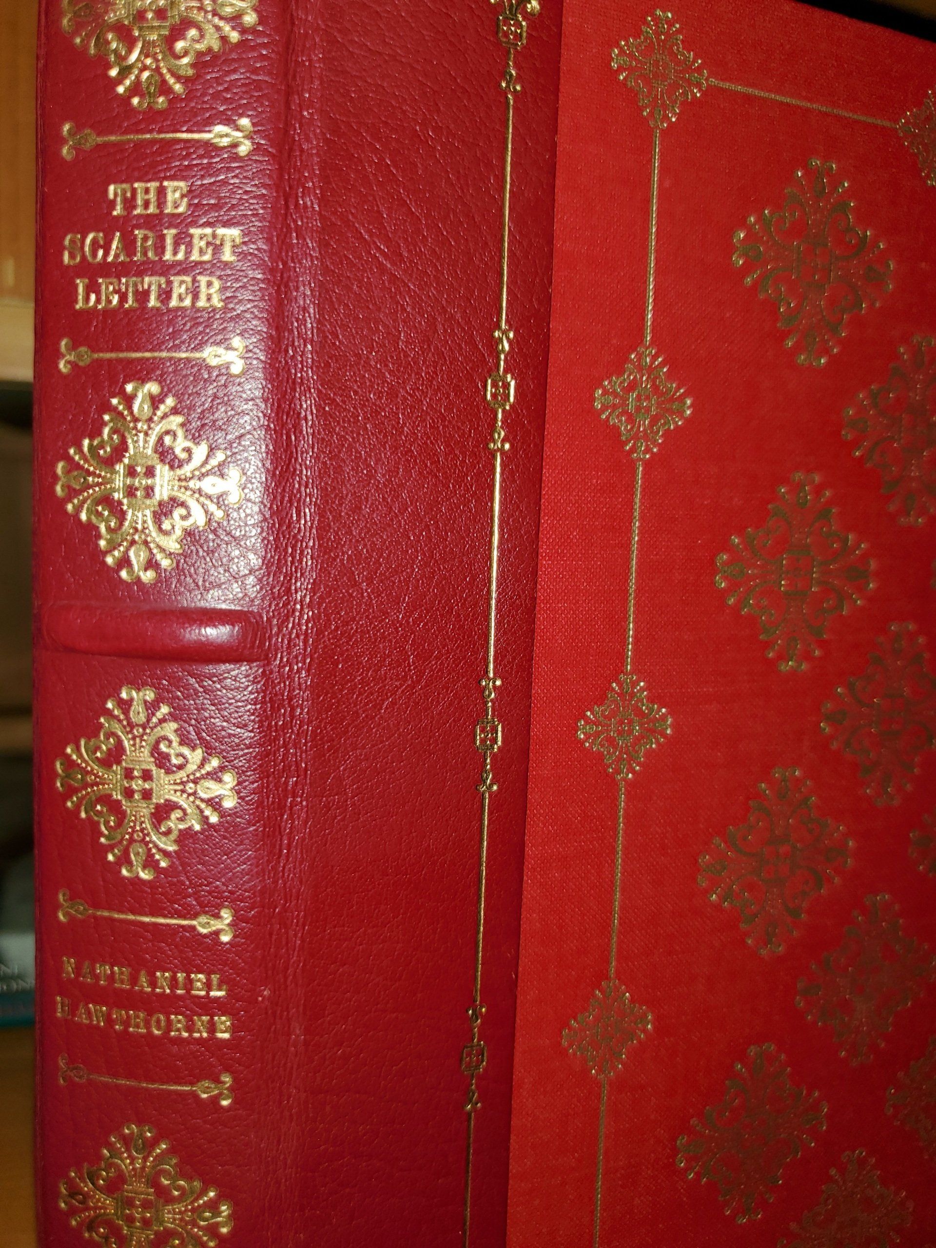 Red book spine and cover with gold lettering and decorative patterns; 