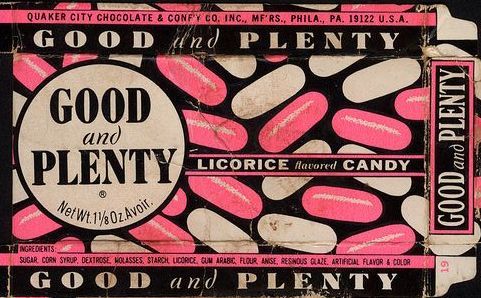 Box of Good & Plenty licorice candies. Black and pink design with text and candy illustrations.