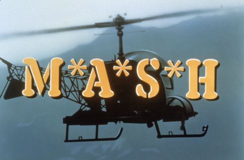 M*A*S*H logo with a silhouette of a helicopter in flight over a mountainous landscape.