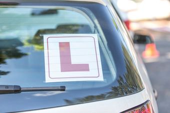 L Plate sticker on the rear window of a silver car