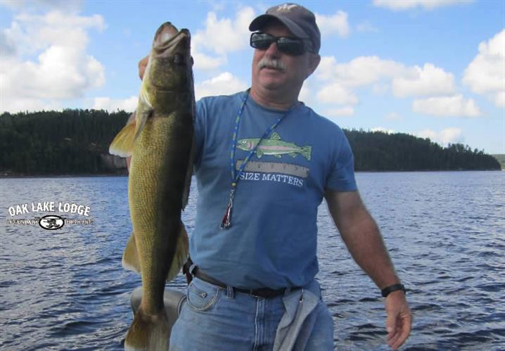 Walleye fish held by fisherman on Oak Lake.
