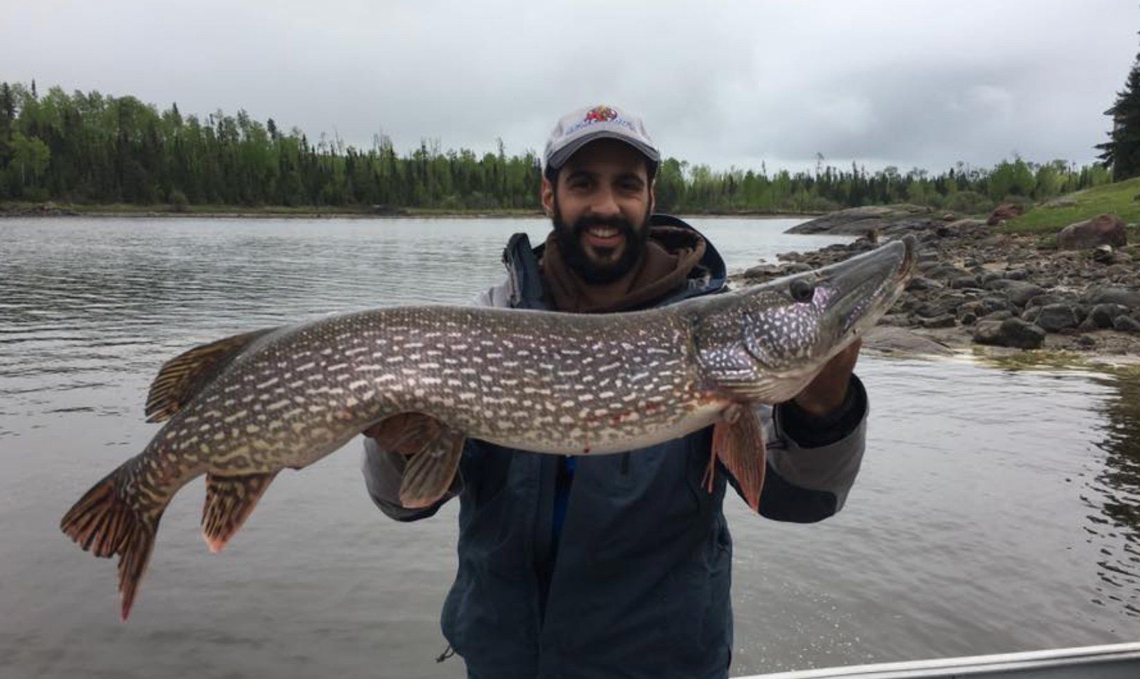 David with a very big fish either a muskie or northern pike.