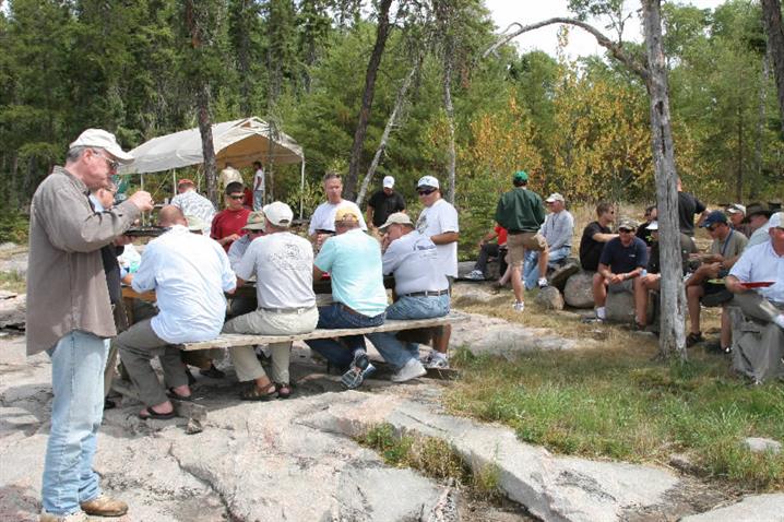 A group enjoying a fish fry on the shores of Oak Lake.