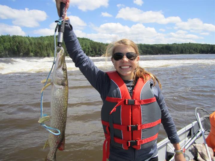 Small muskie held by girl fishing in Canada.