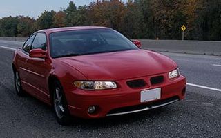 Red car on road - Insurance agency in Stoughton, MA Red car on road - Insurance agency in Stoughton, MA