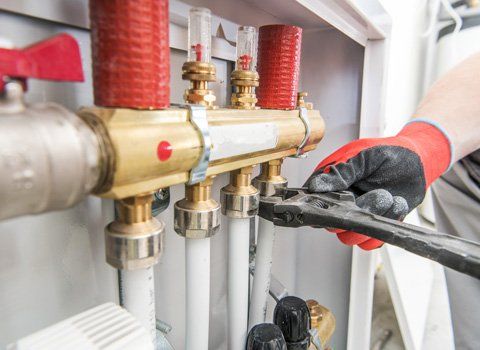 Water Heaters — Plumber Fixing A Pipe System In Staten Island, NY Water Heaters — Plumber Fixing A Pipe System In Staten Island, NY