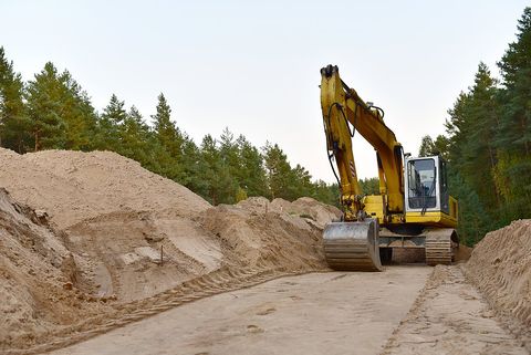 excavator truck flattening driveway
