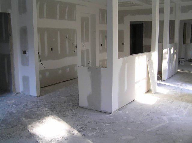 Photo of a home renovation project in progress, the drywall is recently installed. Is now taped and mudded. Awaiting to be finished.