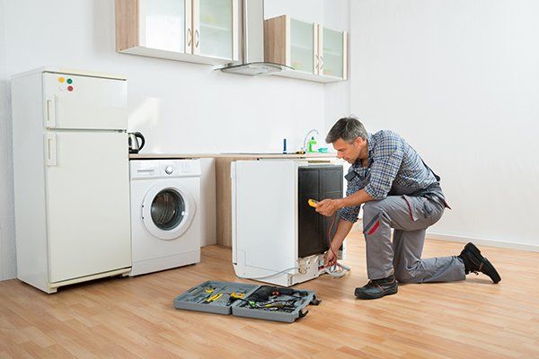 Technician Checking Dishwasher with Digital Multimeter — Lake Worth, FL — Maurice Appliance Service Technician Checking Dishwasher with Digital Multimeter — Lake Worth, FL — Maurice Appliance Service