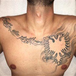 A man has a tattoo of an eagle on his chest