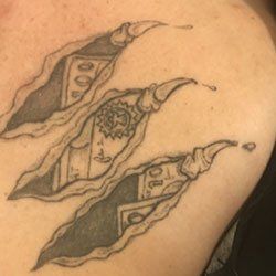 A close up of a tattoo on a person 's back that looks like a pea pod.