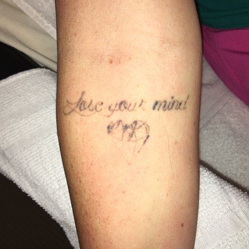 A woman has a tattoo on her arm that says 