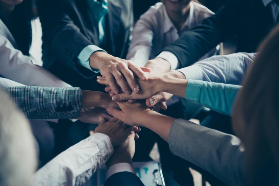 team joining hands